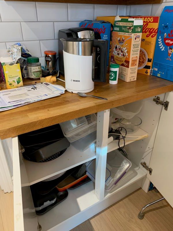 kitchen 1 Original loft area, everything is piled on the floor, with boxes and items haphazardly strewn around. There is no space to walk across the space to reach anything at the far wall