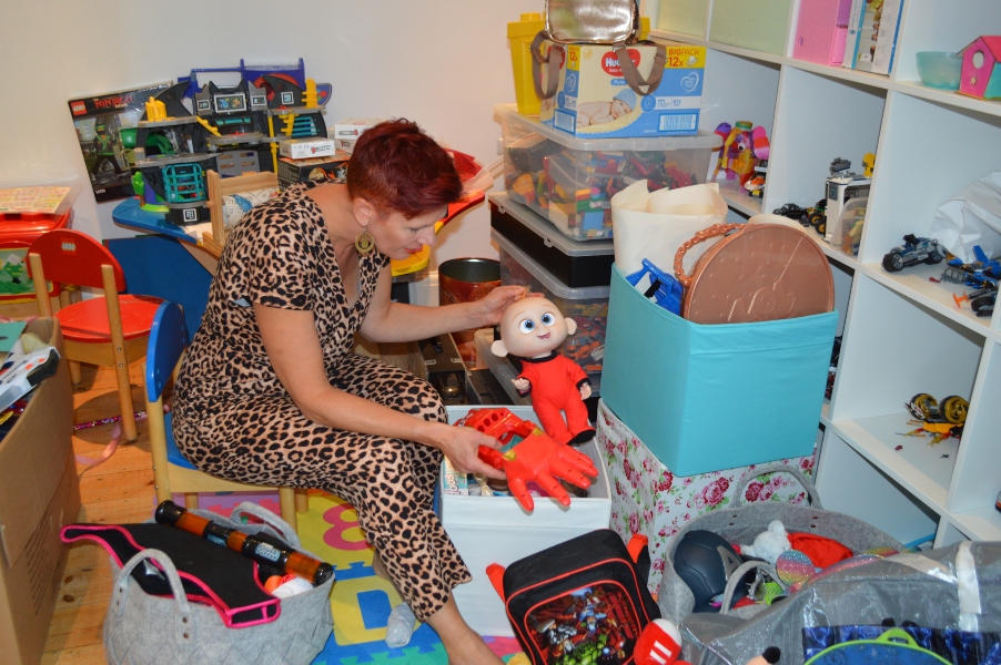 playroom 2 Original loft area, everything is piled on the floor, with boxes and items haphazardly strewn around. There is no space to walk across the space to reach anything at the far wall